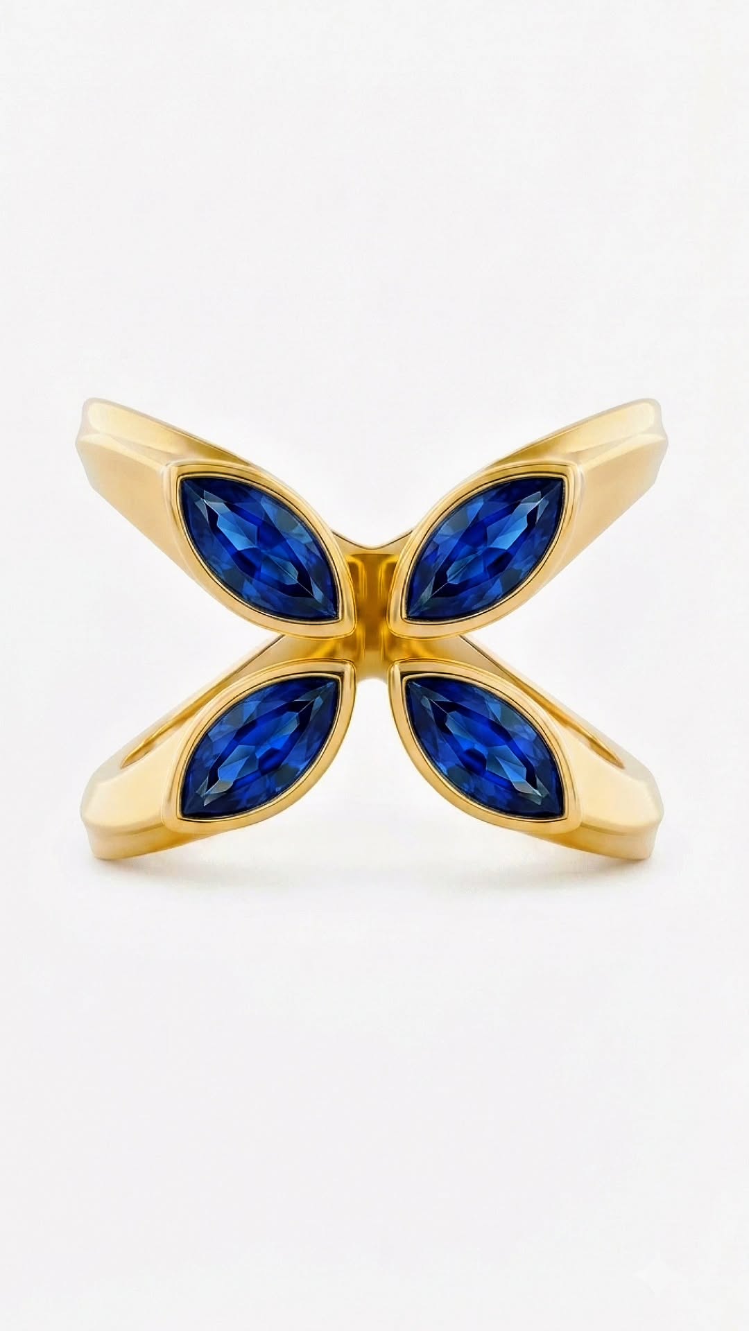 Quatrefoil Ring — four marquise natural blue sapphires set in champagne gold-plated sterling silver 925, studio shot on ivory.